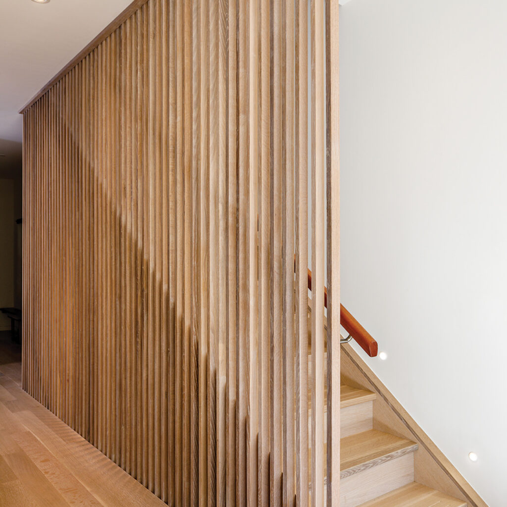 Wooden lamella wall next to staircase